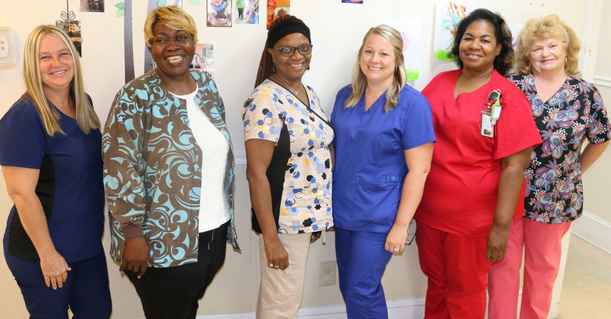 Pence Place nurses take a break from caring for the residents: left to right, Dana Mahar, LPN; Cathy Adams, LPN; Mary Marshall, LPN; Beth Patterson, LPN; Carolyn Caple, RN, and Judy Crowley, RN. Missing from the photo are Tiffany Vidrine, LPN; Sheryl Davis, LPN; and Rebekah Monroe, LPN.