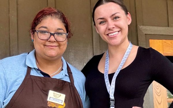 Daphne Hutchison (left) and ESP Alexis Prunczik (right) standing side by side outside Alexis’s new place of employment, smiling and embracing a new chapter.