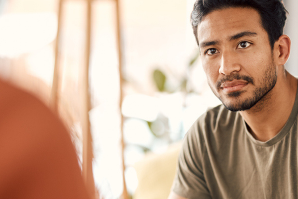 a man working with mental health professional in his home