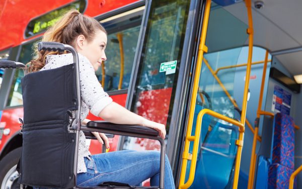 woman in wheelchair using public transportation