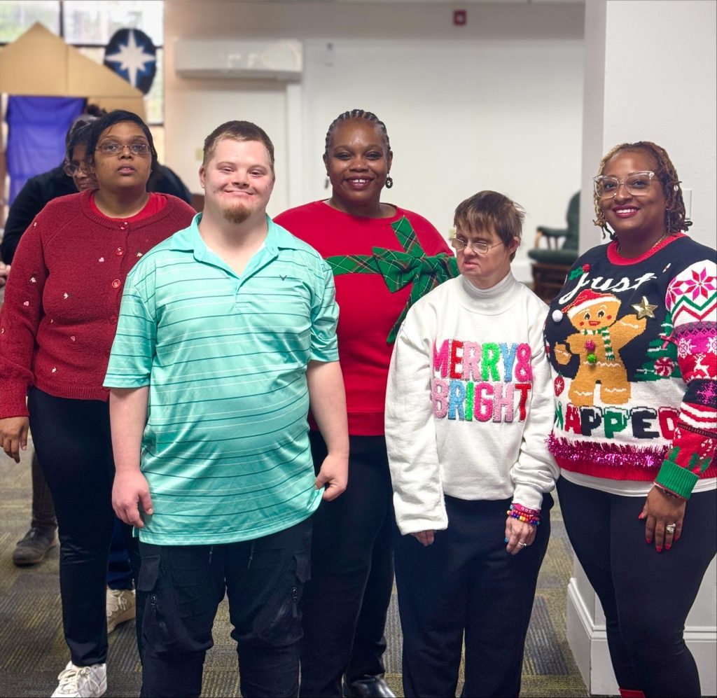 Group wearing festive holiday sweaters.