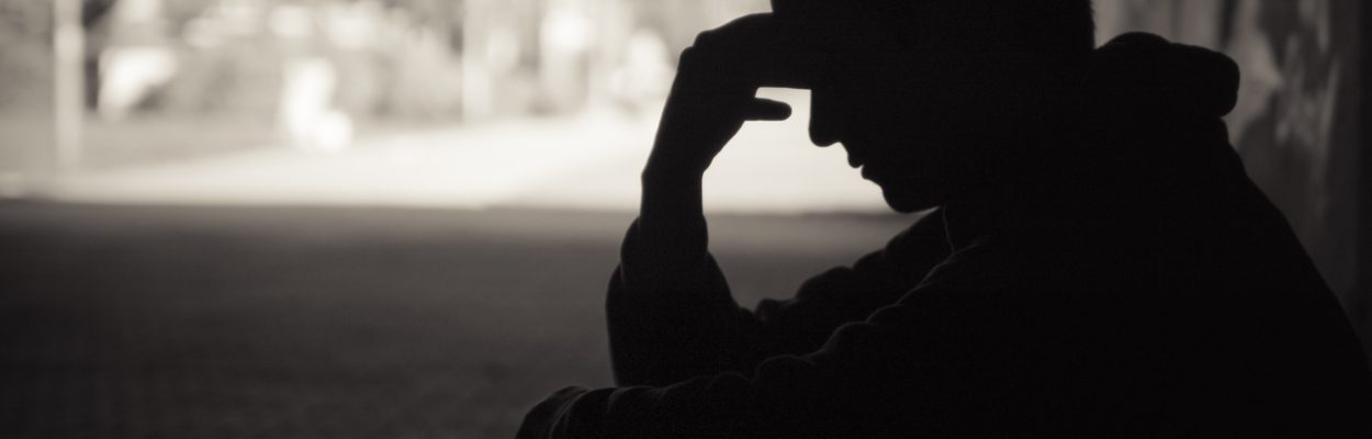 Silhouette of a person in thought.