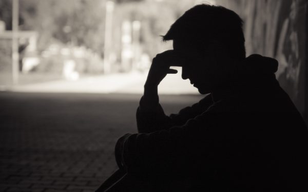 Silhouette of a person in thought.