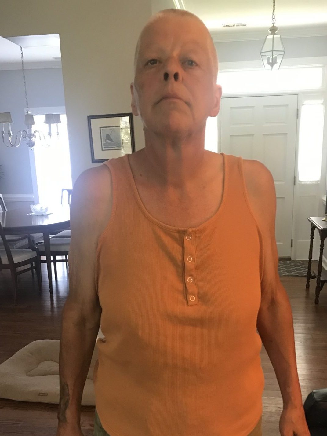 Person in orange tank top indoors looking unhappy.

Laura before beginning her behavioral health journey.