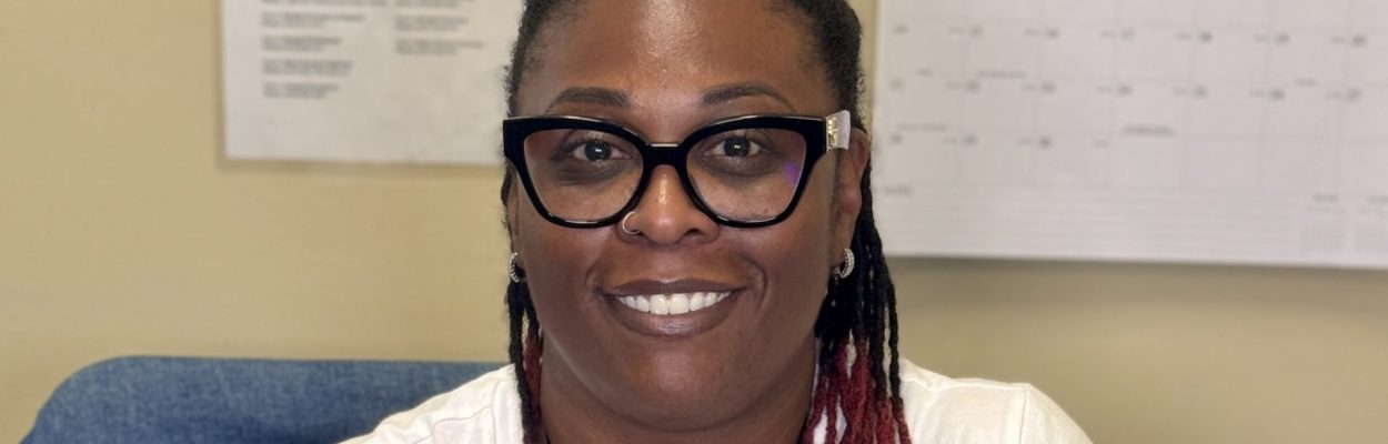 Smiling woman in office setting.