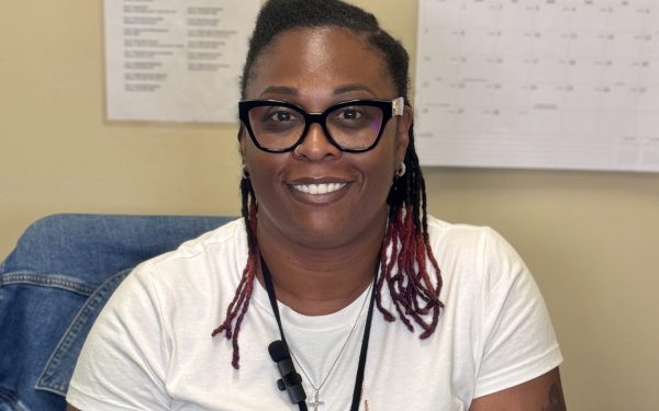 Smiling woman in office setting.