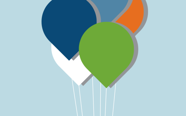 Colorful balloons against light blue background