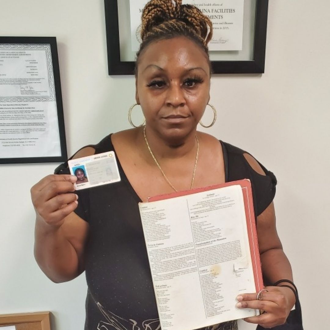 Azalea Gardens resident Sabrina Bolden holds her new driver's license and a poem that she had published.
