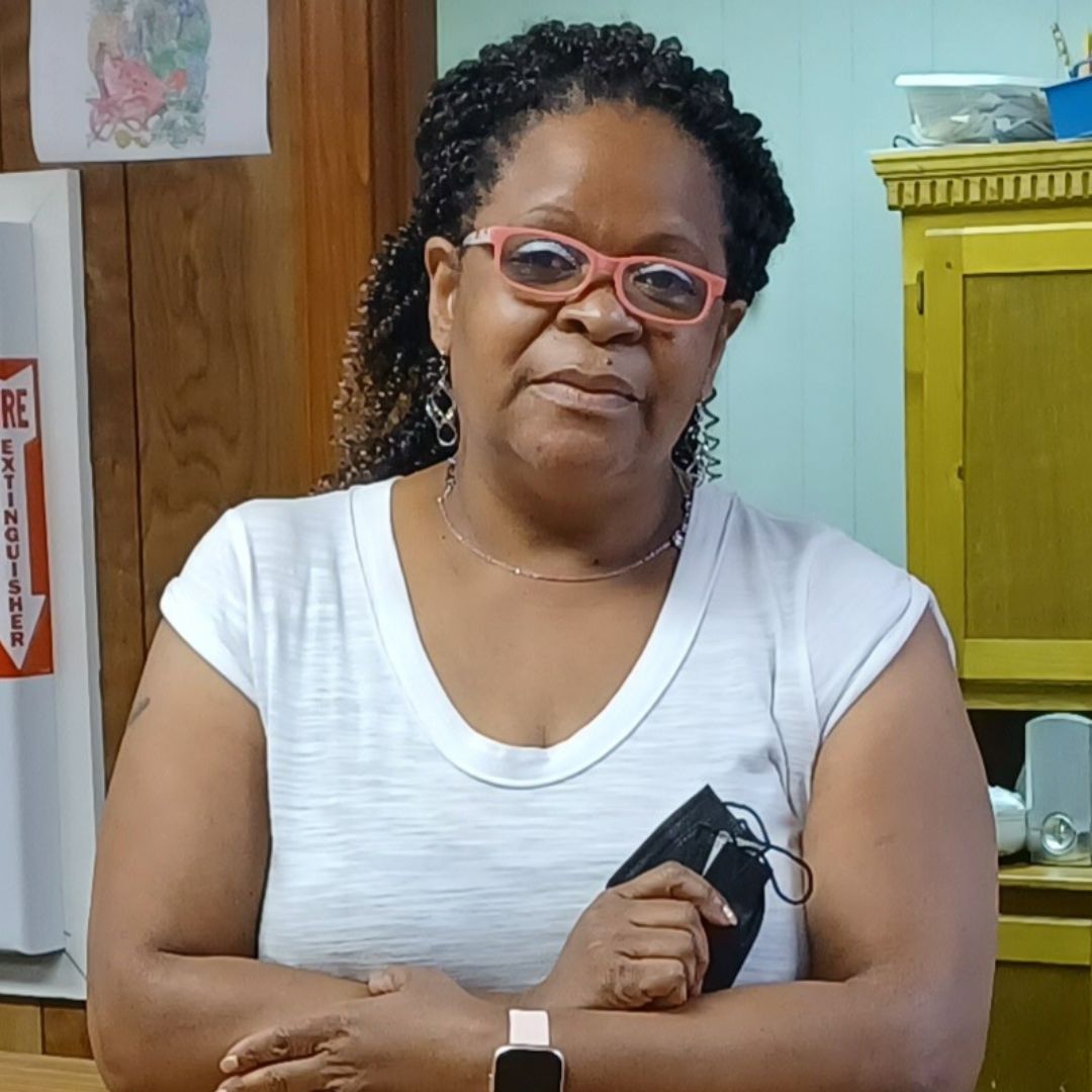 Gail Whitehurst dressed in a white top and wearing glasses.