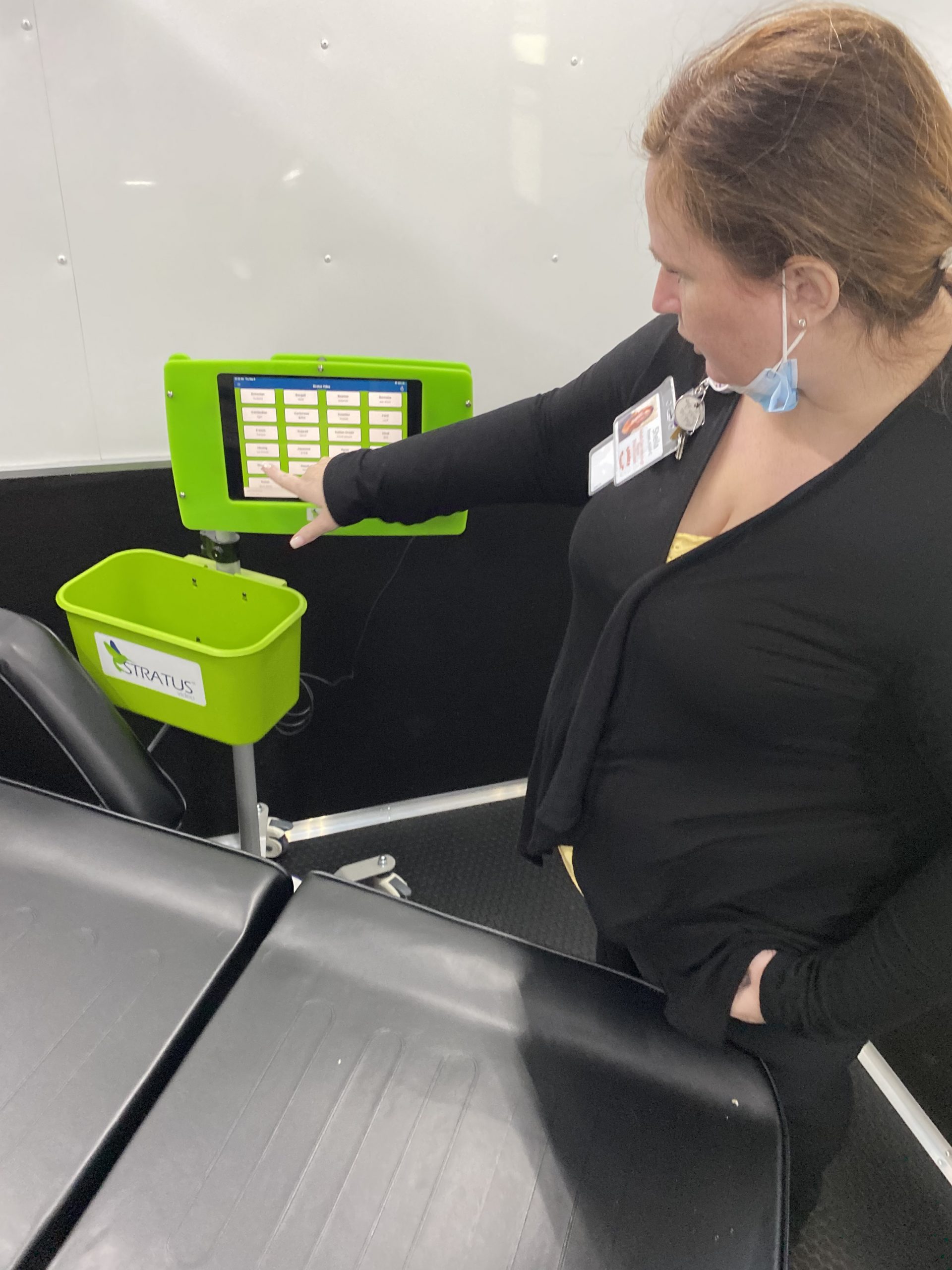 Nurse Practitioner Sheila Brown demonstrates the Stratus video device available on Goshen Medical’s mobile unit that can connect with language translators to communicate with patients.