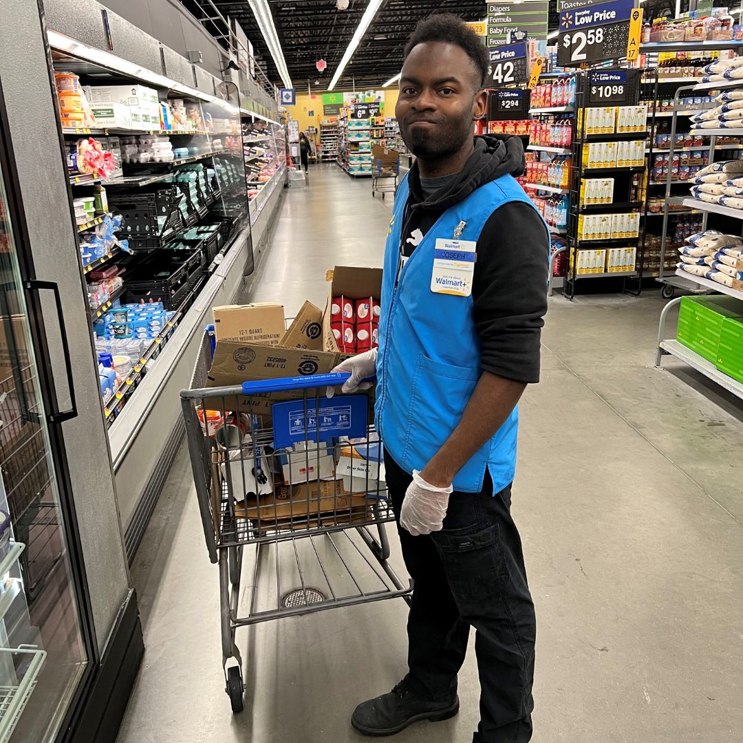 Joseph Hauser, supported through Monarch's IPS team, shows some of his tasks on the job at Walmart.
