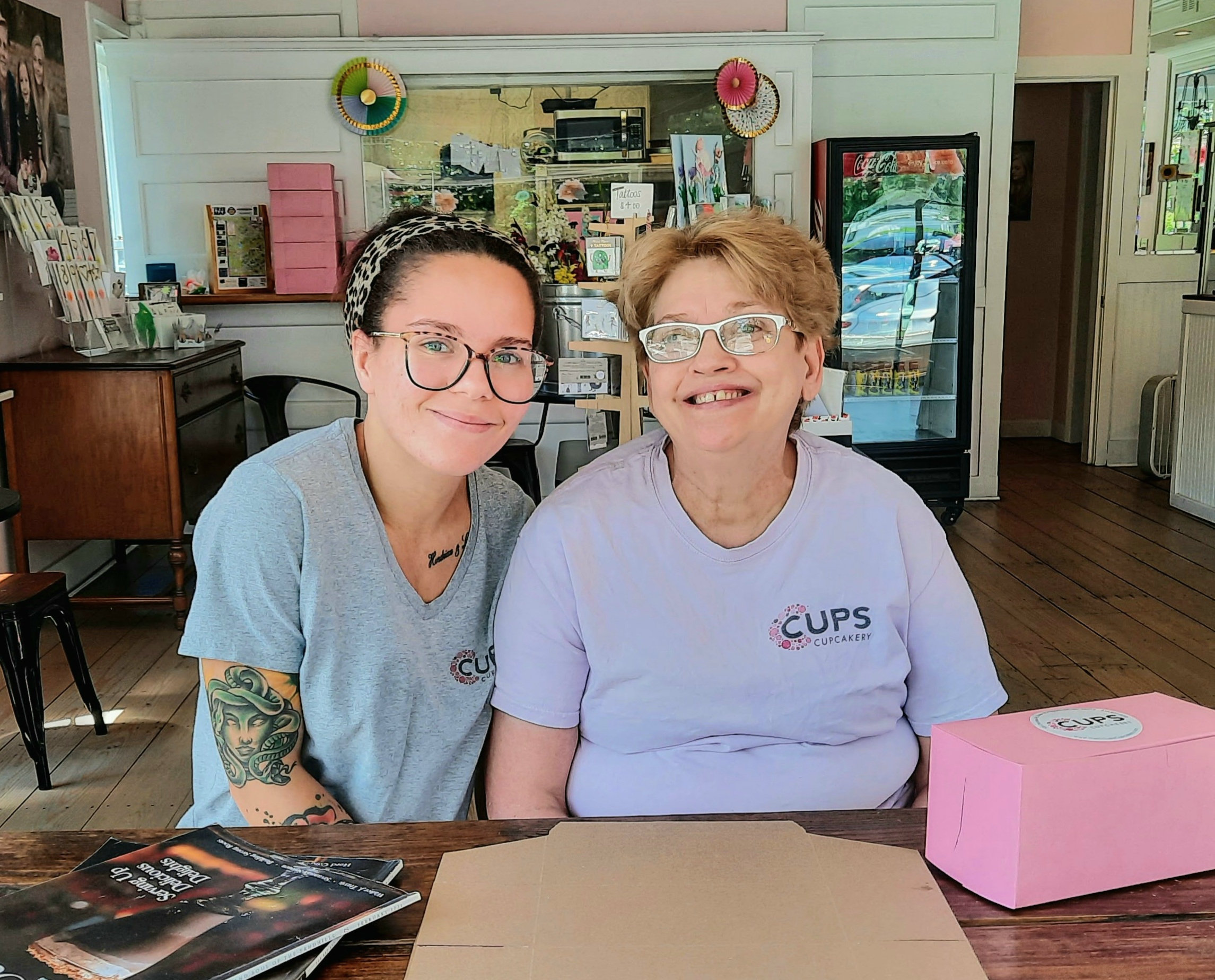 Linda Tyndall (right) sits with her colleague Kayla Burton (left) at C. Cups Cupcakery in Pinehurst.   