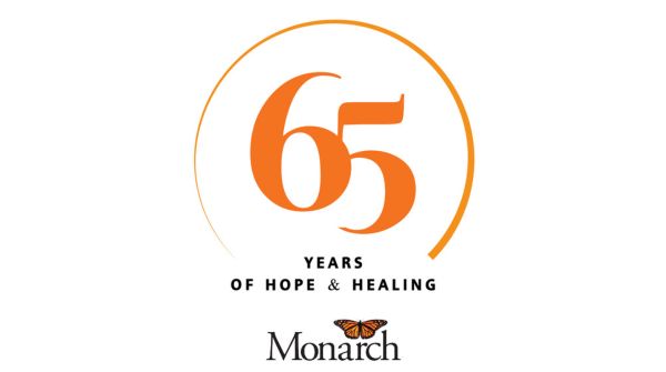 orange and black Monarch logo with the numbers 65 in the middle with a partial circle around it