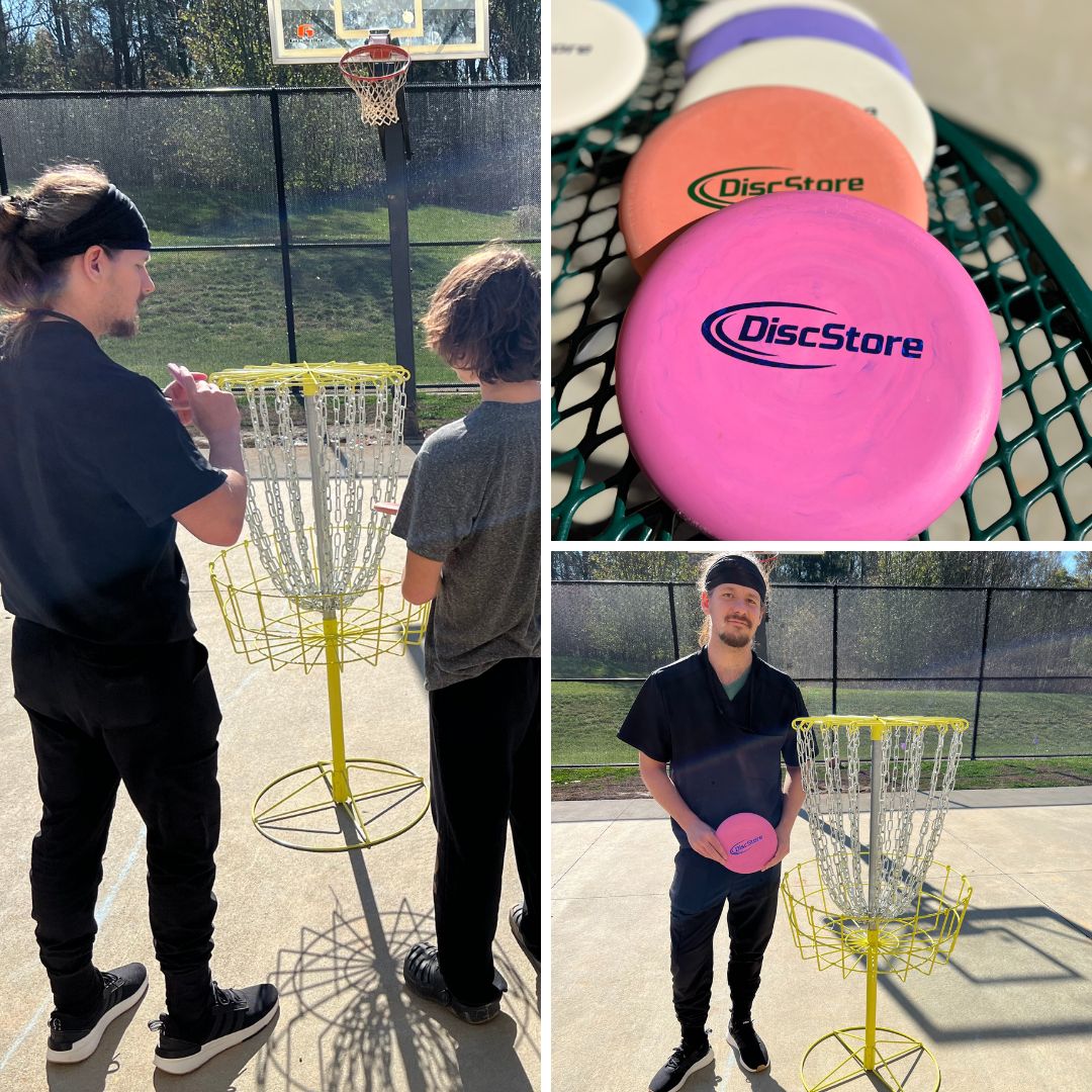 Certified Occupational Therapist Josh Ritchie shows a YCC participant how to hold a disc and how to throw into the hoop or cage.